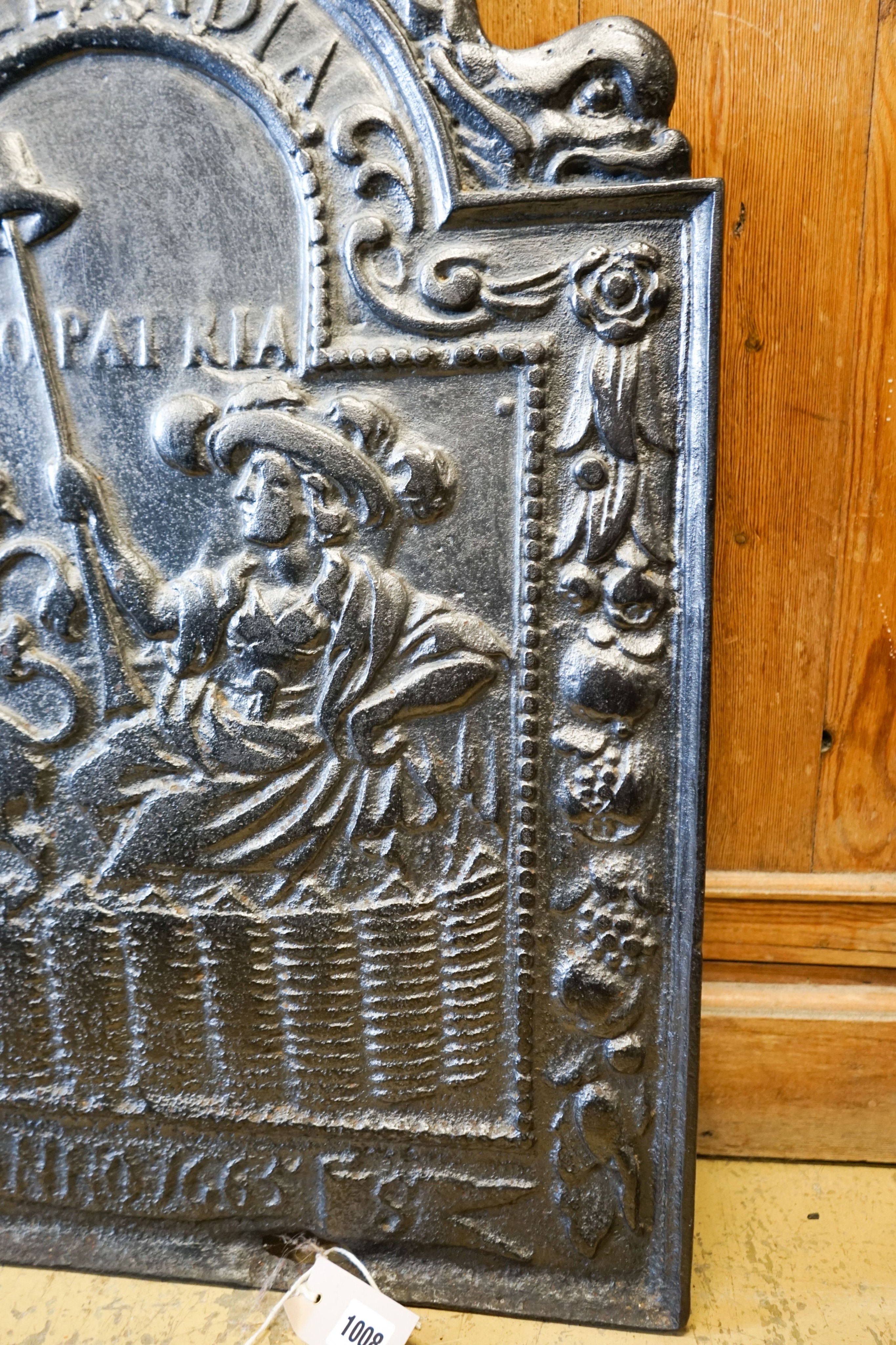 A cast iron fireback inscribed 